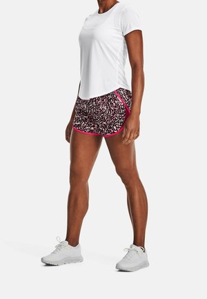 Camiseta atlética de manga corta blanca combinada con pantalones cortos de patrón multicolor con acentos rosas y zapatillas deportivas gris claro.
