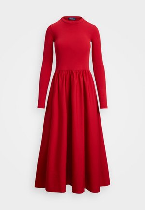 Long-sleeve red dress with a round neckline, fitted bodice, and flared skirt. Made of stretchy fabric; gathered waist detail.