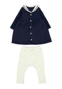 Navyblauwe babyjurk met witte zeeman kraag en knopen, gecombineerd met witte babylegging met elastische taille.
