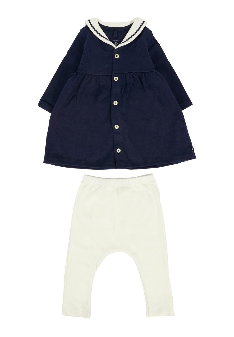Navyblauwe babyjurk met witte zeeman kraag en knopen, gecombineerd met witte babylegging met elastische taille.