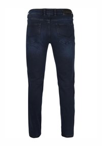 Dark blue denim jeans featuring a slim fit, five-pocket design, and a branded leather patch on the back waistband. Smooth texture.