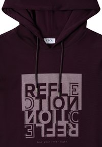 Dunkelviolette Kapuzenjacke mit einem reflektierenden quadratischen Grafikdesign, das den spiegelverkehrten Text "REFLEXION" zeigt und die Phrase "finde dein inneres Licht" darunter.