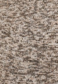 Knitted fabric in earthy tones of brown and beige with a textured, layered appearance. Wool blend with varied thickness throughout.