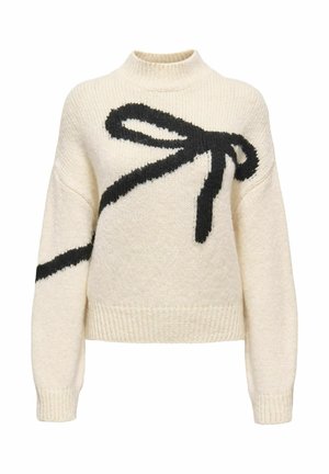 Grober Strickpullover in Creme mit einem schwarzen, übergroßen Schleifendesign auf der Vorderseite. Hat einen hohen Kragen sowie gerippte Bündchen und Saum.