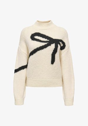 Maglione lavorato a maglia grossa color crema con un grande fiocco nero sopra il davanti. Caratterizzato da un collo alto e polsini e orlo a costine.