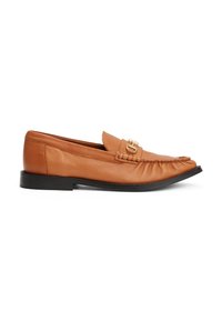 Brown leather loafer with stitched detailing, gold buckle on top, and black flat sole, shown from the side on white background.