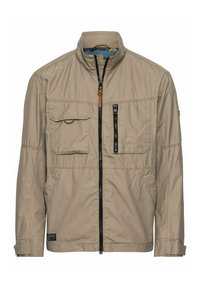 Beige Reißverschlussjacke mit hochgeschlossenem Kragen, zwei vorderen Klappentaschen, einer vertikalen Reißverschlusstasche und gesteppten Details. Hat ein Innenfutter mit Muster.