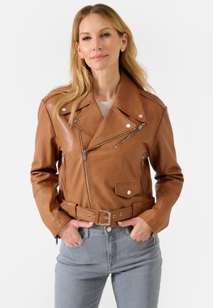 Brown leather motorcycle jacket with zippered pockets, belted waist, and silver hardware accents. Smooth texture and tailored design.