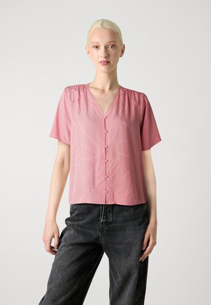 Roze blouse met korte mouwen en V-hals, met een subtiel bladpatroon en knoopsluiting aan de voorkant. Zacht materiaal, relaxte pasvorm en textuurdetail.
