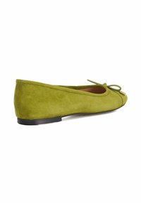 Green suede ballet flat with a pointed toe, a small bow detail on the front, and a flat black sole. Smooth texture and minimalist design.