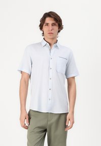 Light blue short-sleeve shirt with a front pocket, buttoned placket, and subtle striped detail near the collar. Material appears lightweight.