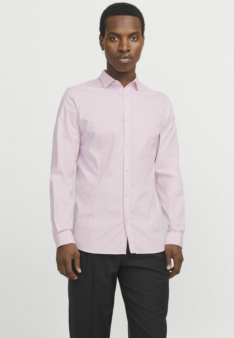 Helles rosa Button-Down-Hemd mit spitzem Kragen, langen Ärmeln und schlanker Passform. Aus glattem Stoff mit subtiler Textur gefertigt.