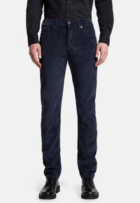 Pantaloni di velluto a coste blu navy con taglio dritto, dotati di zip frontale, tasche anteriori e una sottile texture a coste verticali.