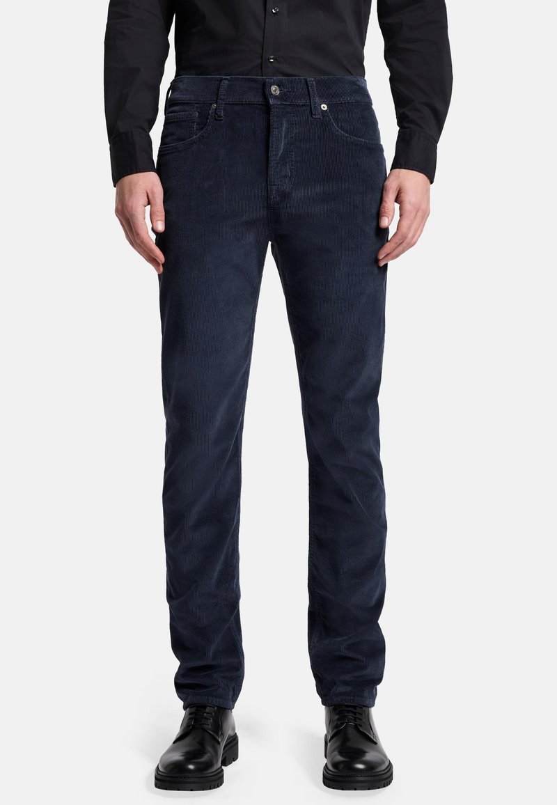 Pantaloni di velluto a coste blu navy con taglio dritto, dotati di zip frontale, tasche anteriori e una sottile texture a coste verticali.