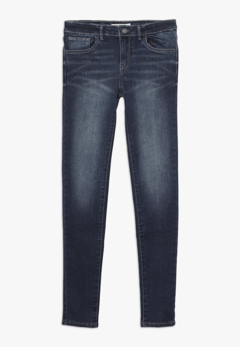 Jean slim bleu foncé avec poches devant et derrière, passants de ceinture et détails délavés sur les cuisses et les genoux.
