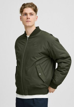 Olive green bomber jacket with a zip front, knit collar, and two side pockets. Smooth fabric with a slight sheen and simple logo detail.