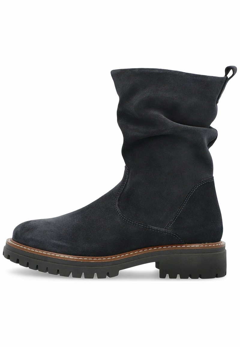 Black suede ankle boot with slouchy upper, rounded toe, contrasting light stitching, and chunky rubber sole with tread pattern.