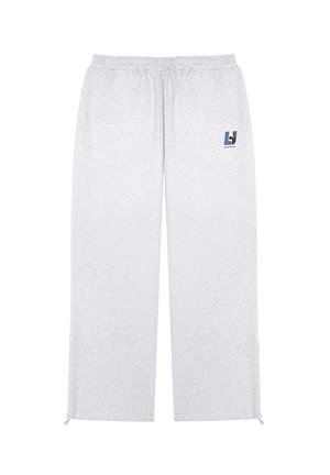 Szare dresy wykonane z miękkiego materiału, z elastycznym pasem, bocznymi kieszeniami i małym akcentem logo po lewej stronie.