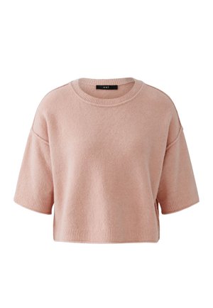 Soft pink cropped sweater with short sleeves and a round neckline, featuring ribbed cuffs and hem, labeled "oui" inside collar.