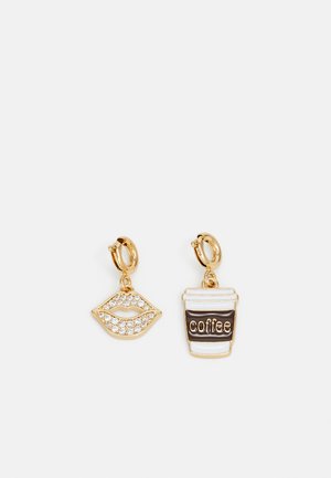 Gold-tone earrings featuring a sparkling lips charm and a coffee cup charm with brown text, set against a white background.