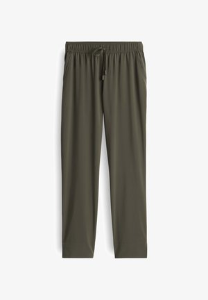 Lightweight, olive green athletic pants with a drawstring waist, side pockets, and a tapered leg design, made from a smooth, breathable fabric.
