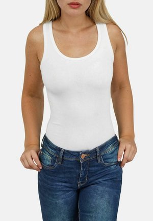 White sleeveless tank top with a rounded neckline paired with blue jeans featuring front pockets and a button closure.