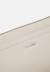 Calvin Klein MUST CONVERTIBLE CAMERA BAG - Torba preko tijela - sand pebble