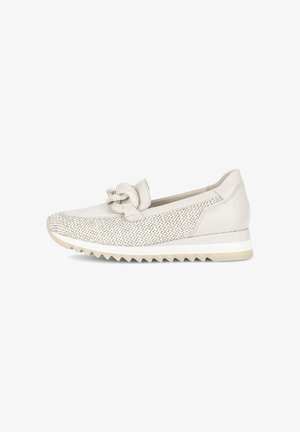 Beige sneaker with woven mesh upper, textured bow detail, and a white rubber sole featuring zigzag tread for grip.
