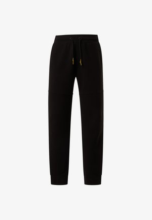 Schwarze Sweatpants mit elastischem Bund, verstellbarem Kordelzug, Seitentaschen und schmalem Beindesign. Weicher Stoff und minimale Nahtdetails.