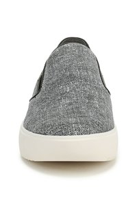 Black and white textured slip-on shoe with a rounded toe and a white rubber sole, featuring a smooth black accent on the sides.
