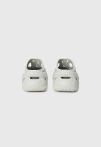 Light gray rubber clogs with a ventilation design, rounded shape, and textured sole. Features a brand logo on the strap.