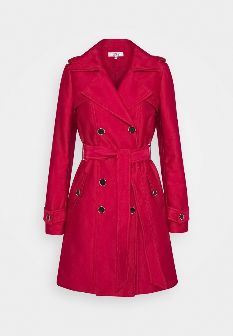Trench-coat rouge croisé avec larges revers, boutons noirs, ceinture à la taille et poignets boutonnés, présenté sur un fond uni.