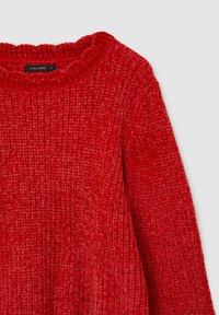 Maglione rosso a coste con colletto rotondo e testurizzato e maniche lunghe. Il tessuto presenta un aspetto morbido e peloso con cuciture visibili.