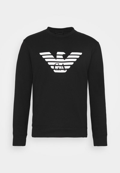 Juodas ilgomis rankovėmis sportinis megztinis su apvali kaklo iškirpte ir baltu liniuotės erelio logotipu su "GA" centre, pagamintas iš minkštos, tekstūrines medžiagos.