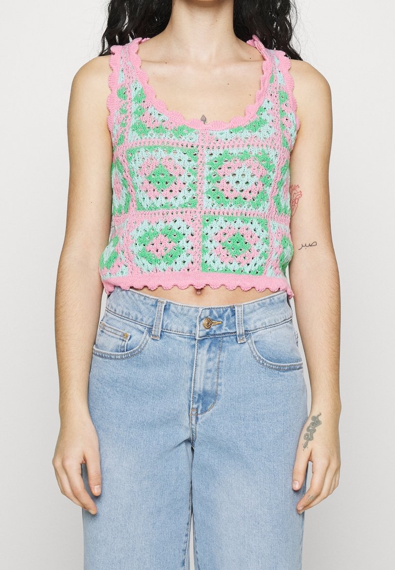Crochet crop top in pastel green, pink, and blue with scalloped edges; features a geometric pattern, fitted design, and openwork texture.