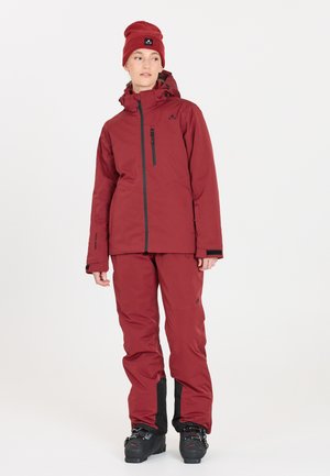 Maroon insulated ski jacket with hood and zippered pocket, paired with matching pants featuring black accents and a fitted beanie.