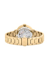 Orologio dorato con cinturino in acciaio inox, cassa rotonda, retro trasparente che mostra i dettagli del movimento e corona di carica a ore 12.