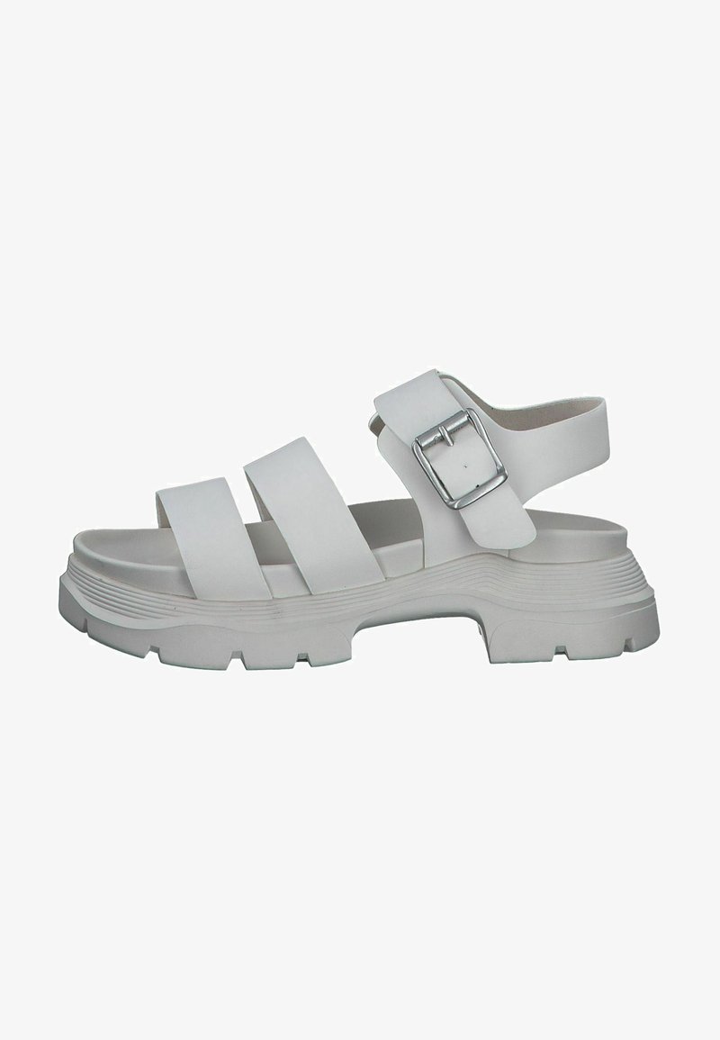 White sandal with multiple wide straps and a side buckle. Features a textured sole with a chunky design and raised edges.