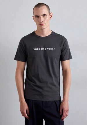 Dark gray short-sleeve t-shirt made of cotton, featuring the text "TIGER OF SWEDEN" in white, round neckline, and a fitted design.