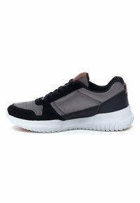 Black and grey athletic shoe with mesh upper, suede accents, white rubber sole, and a lace-up design. Features a round toe and cushioned collar.