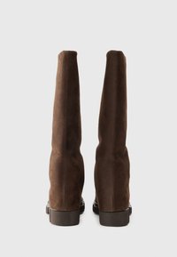 Brown suede over-the-knee boots with a smooth texture, rounded top, and sturdy black rubber sole. No visible hardware or accents.
