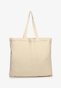 Beżowa torba z płótna z dwiema solidnymi uchwytami. Prosty, nieozdobiony design. Miękka tekstura i przestronne wnętrze.