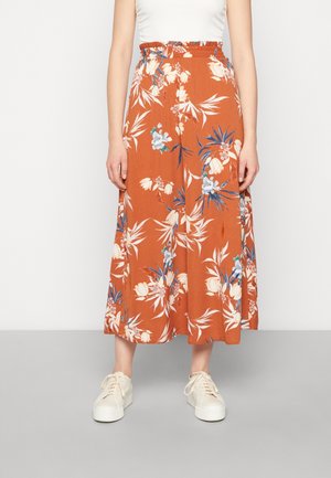 Spódnica midi w kwiatowy wzór w kolorze rdzawego pomarańczu, z czarnym elastycznym paskiem w talii, białymi i niebieskimi kwiatami, lejącym się materiałem i luźnym krojem.
