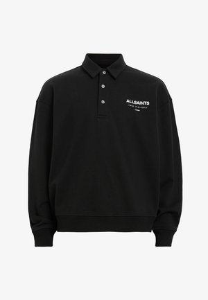 Polo de manga larga negro hecho de una mezcla de algodón, presenta un cuello clásico, una tapeta de tres botones y un logotipo impreso en blanco en el pecho.