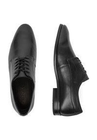 Fekete bőr cipők sima felülettel, fűzős kivitelben és hegyes orral. Minimalista sziluettel és gumitalppal rendelkezik.