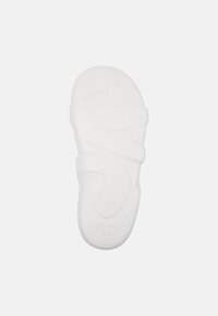 White rubber shoe sole with curved design features, textured patterns, and size 42 marked on the bottom. Logo visible at the top.