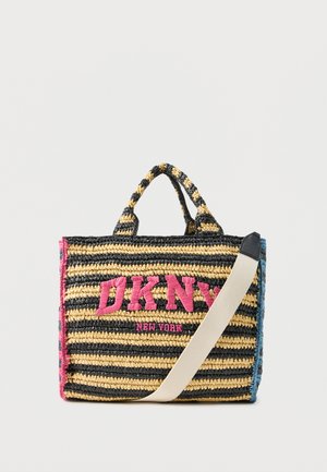 Striped woven tote bag with black, yellow, and blue colors, pink "DKNY New York" logo, dual handles, and a detachable beige shoulder strap.