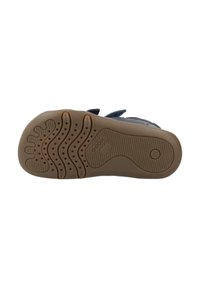 Schoenenzool met een gestructureerde bruine rubberen buitenzool met verschillende grippatronen. Inclusief een logo en maatindicator aan de zijkant.