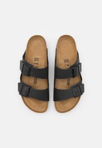 Black leather sandals with two adjustable buckles, cork footbed, and smooth texture. Size 41 printed on the insoles.