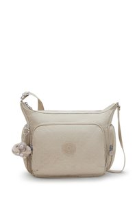 Beige crossbody bag with a textured pattern, featuring a zippered main compartment, front pocket, and a plush monkey charm accent.